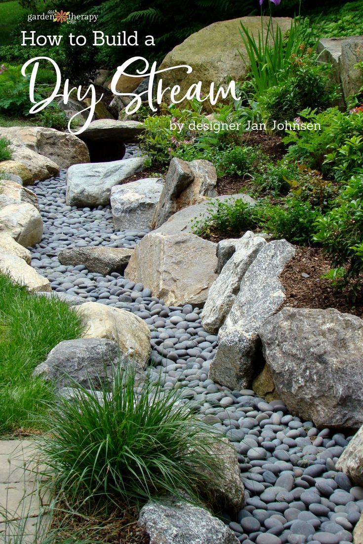 a garden with rocks and grass in it