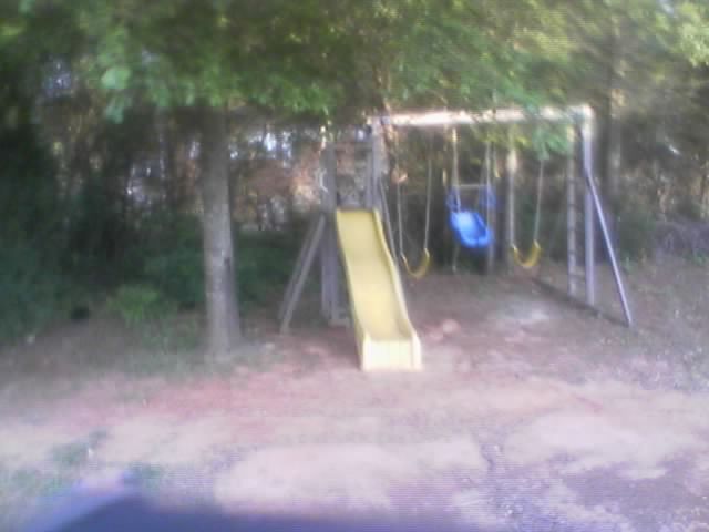 there is a yellow slide in the yard