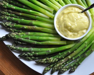 asparagus on a white plate with dip