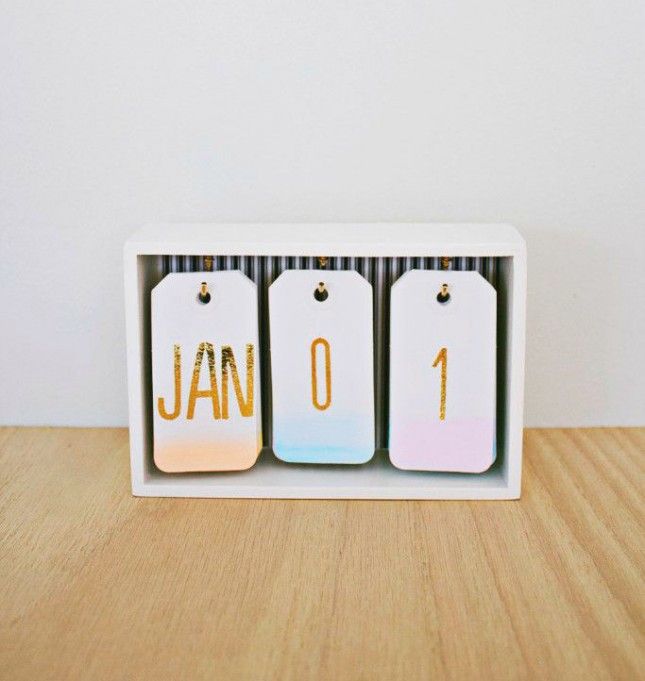 three calendars with the word diy written on them sitting in a white box