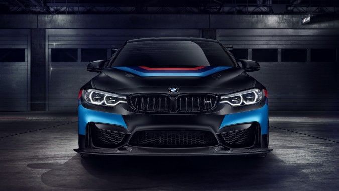 the front end of a blue and black bmw car