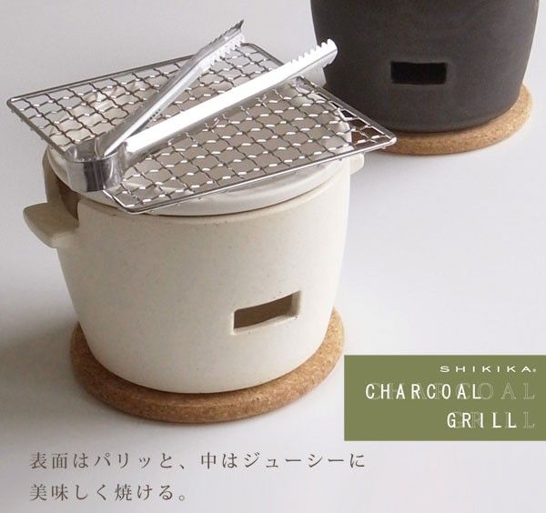 there is a small pot with a grill on it and another container next to it