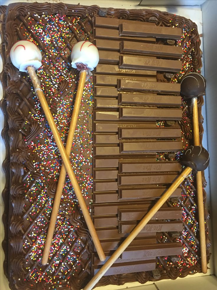 chocolate cake decorated with marshmallows and two spoons on top of it