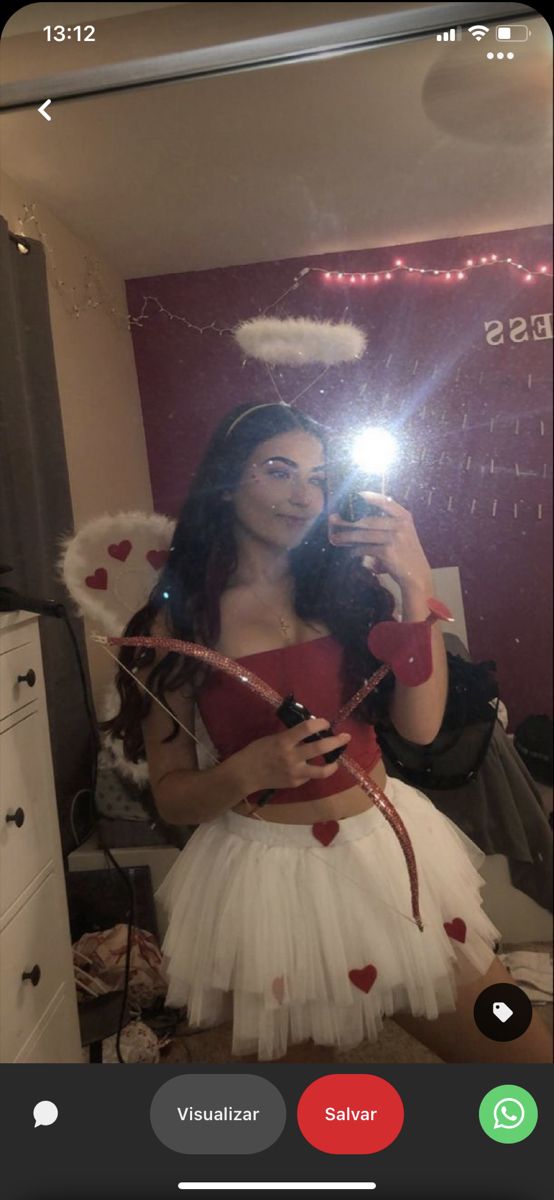 a woman taking a selfie in front of a mirror wearing a santa claus costume