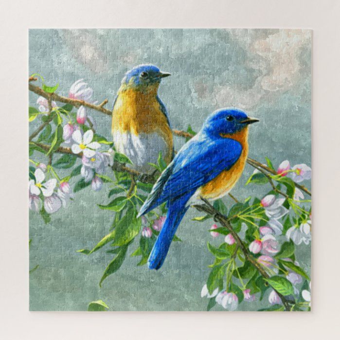 two blue birds sitting on a branch with white and yellow flowers in the foreground