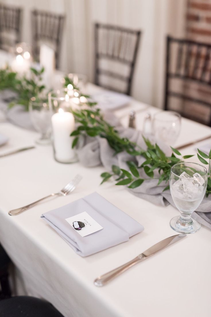 the table is set with silverware and place settings