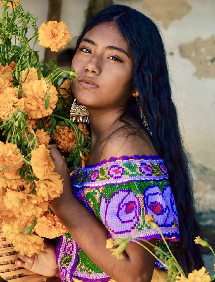 a woman holding flowers in her hands