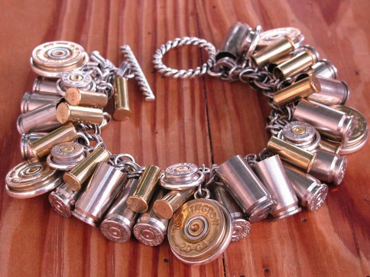 a close up of a bracelet on a wooden surface with lots of different types of buttons