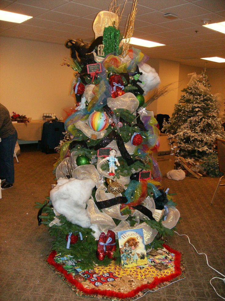 a decorated christmas tree in an office cubicle with decorations on the top and bottom