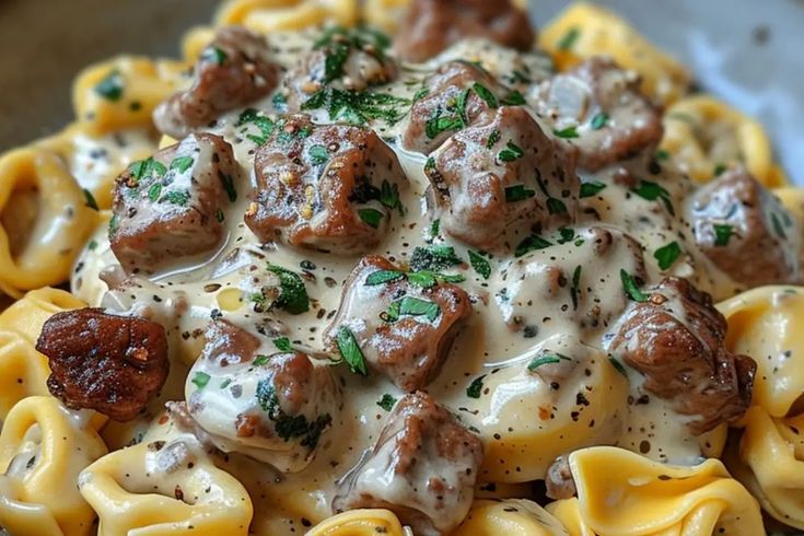 a pasta dish with meatballs and gravy on top