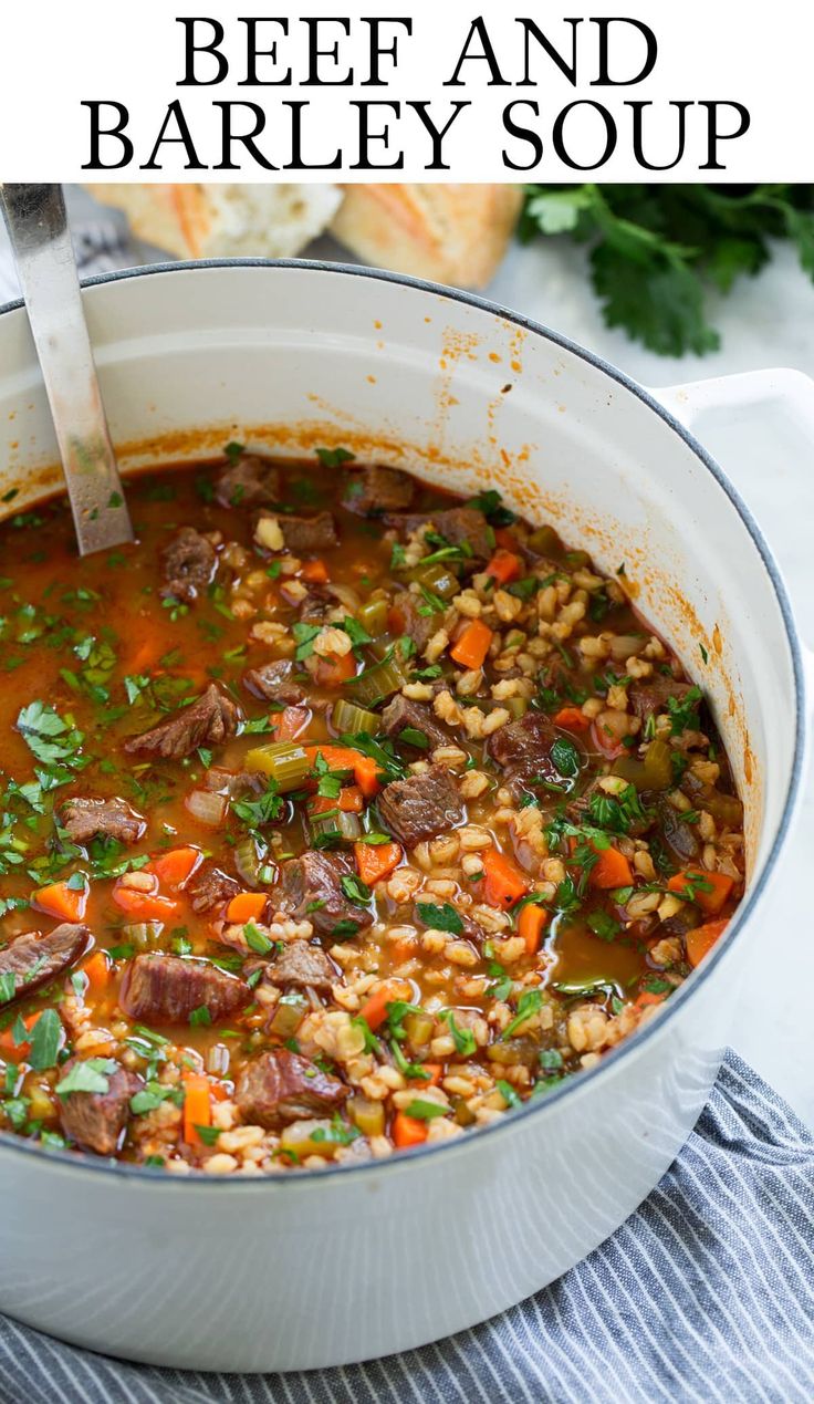 beef and barley soup in a white pot