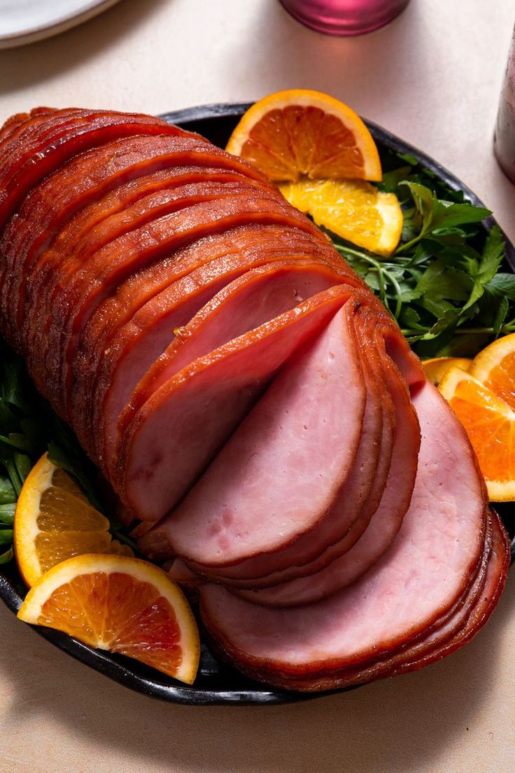 ham and orange slices on a plate with greens