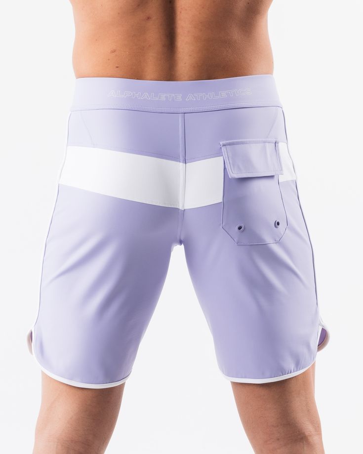 HIGHLIGHTS.. Unlined boardshort. 9” inseam Reflective branding at leg opening and back waistband Elastic waistband with adjustable self-tie drawcords Color-blocking panelling Water resistant fabric FIT SUGGESTION. This item runs true to Alphalete’s standard sizing.. Fit is based off of waist size in inches.. If you are between sizes, we recommend sizing up for a relaxed fit.. Eric is 6’2”/188cm, wearing a size 32. MATERIALS AND WASHING DIRECTIONS. 67% Nylon, 23% spandex. Due to the high saturati White Training Bottoms With Elastic Side Panels, White Sporty Swim Trunks For Water Sports, Sporty Fitted Shorts With Tie-side Bottom, White Surfing Swim Trunks, Fitted White Swim Trunks For Surfing, White Fitted Swim Trunks For Surfing, White Beachwear Bottoms For Water Sports, Sporty White Shorts For Water Sports, White Summer Bottoms With Elastic Side Panels