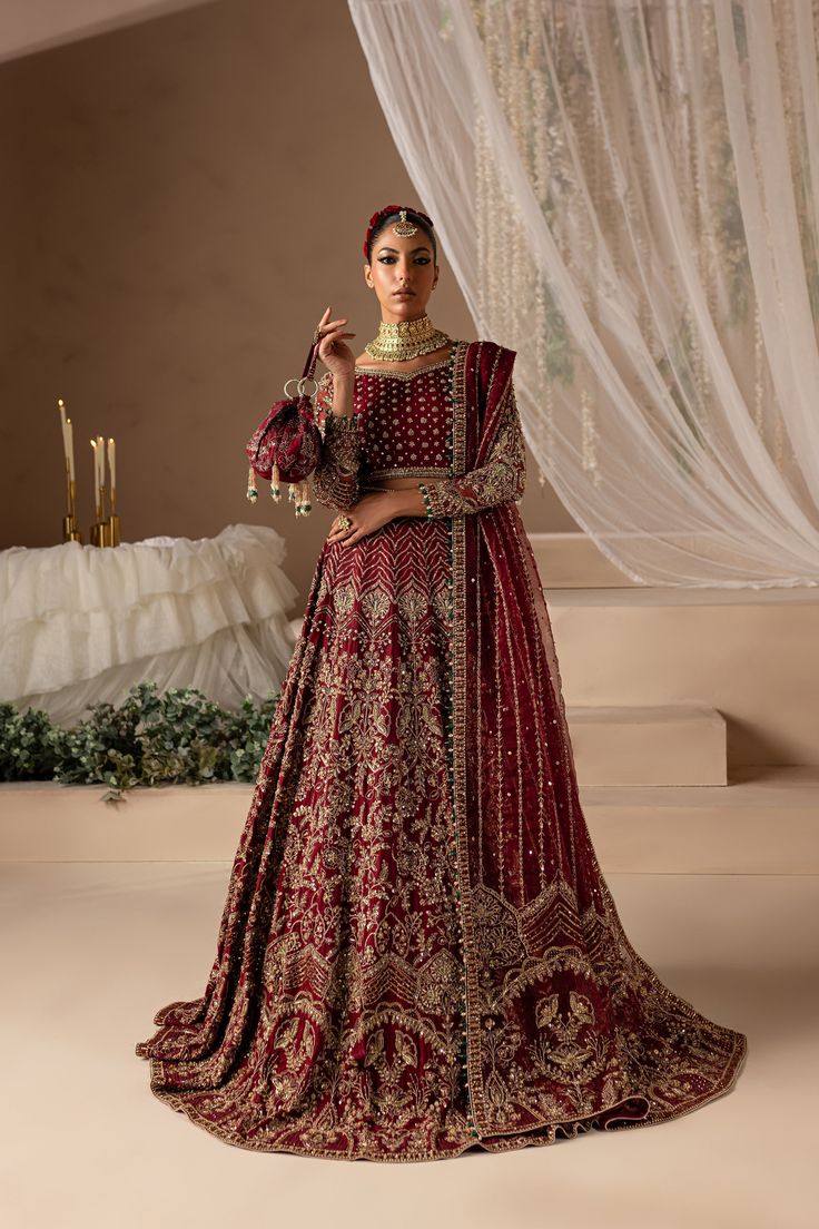 a woman in a red and gold bridal gown