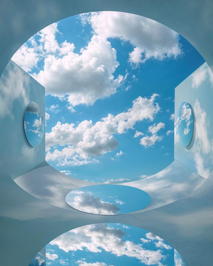 the sky and clouds are reflected in an open window