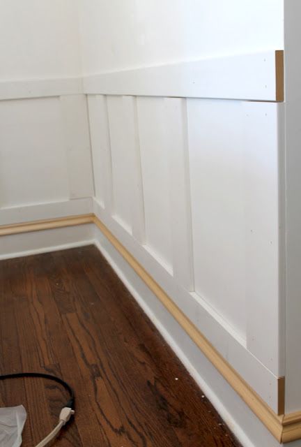 a room with white walls and wood flooring next to a wall mounted heater