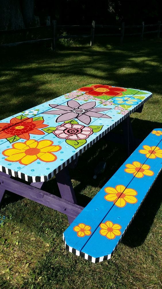 a picnic table painted with flowers on it