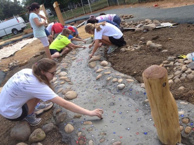 children playing with rocks and stones at the park