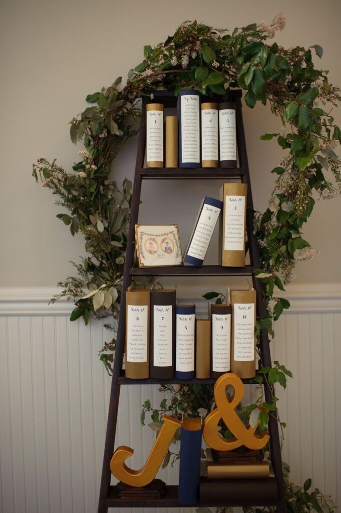 a book shelf filled with books next to a wall mounted planter and decorative items