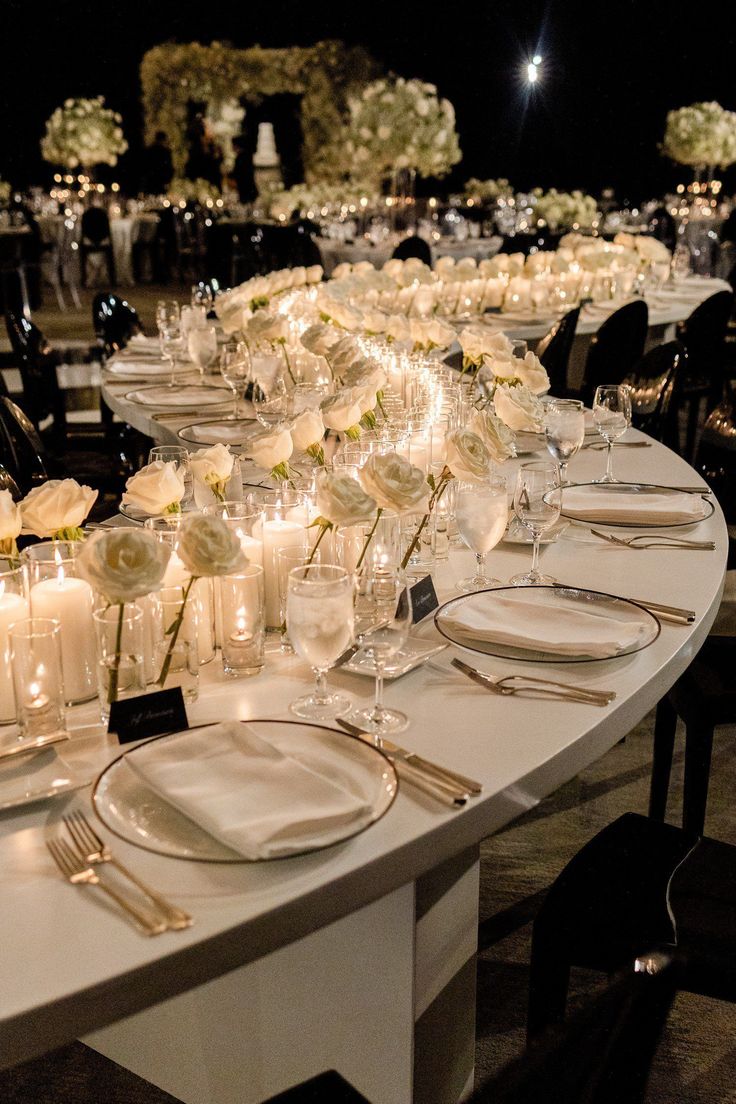 a long table is set with candles and flowers for a formal dinner or wedding reception