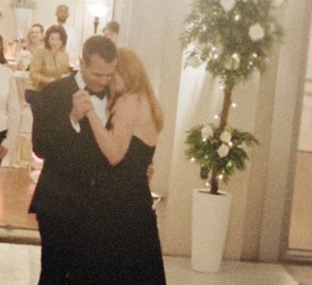 a man and woman are dancing together on the dance floor in front of other people