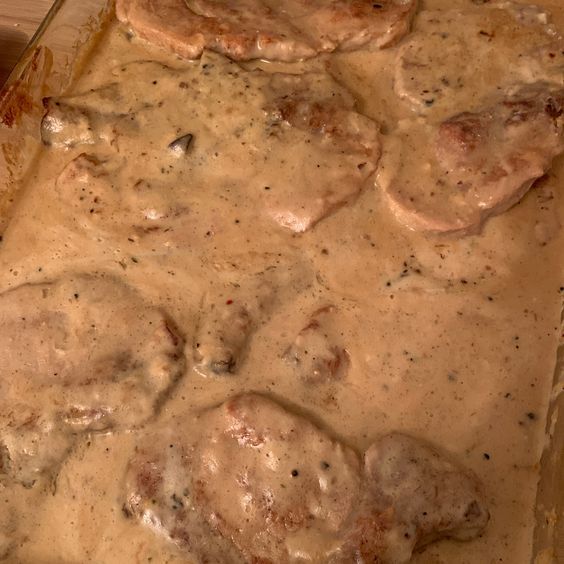 a casserole dish with meat and gravy on it in a pan