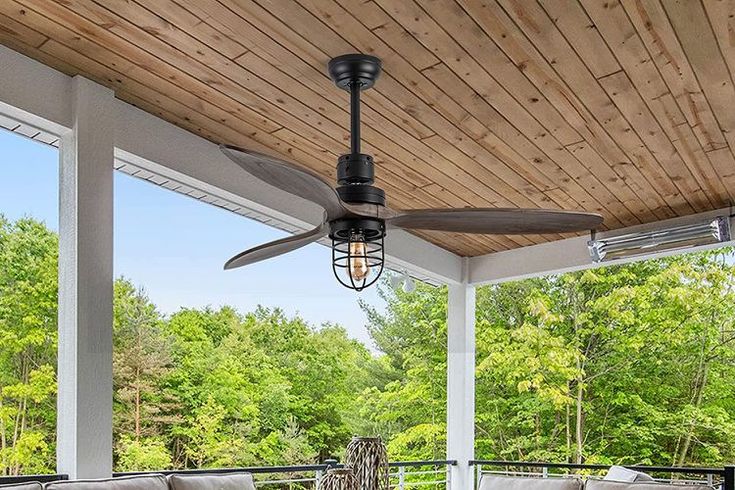 an outdoor patio with furniture and ceiling fan