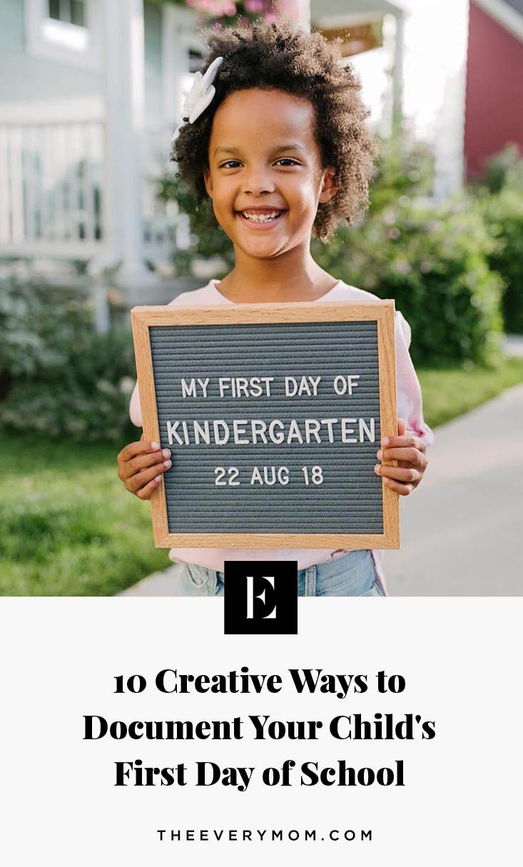 a child holding up a sign that says, my first day of kindergarten