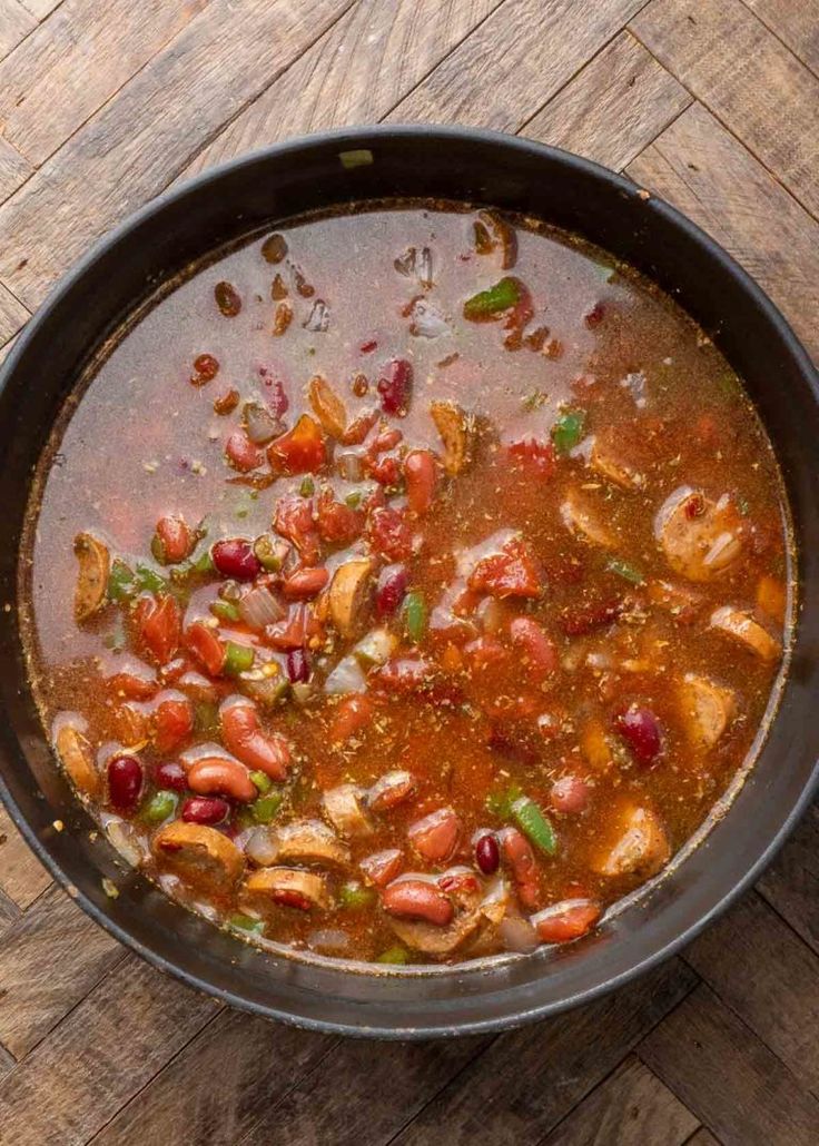 a bowl filled with soup sitting on top of a wooden table