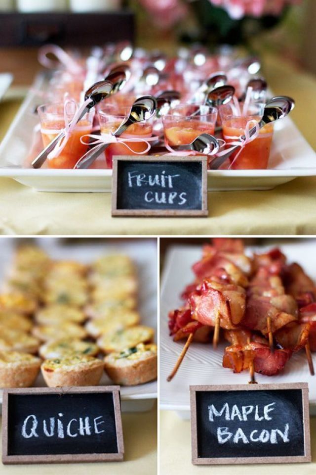 various types of food are displayed on small trays with chalkboards attached to them