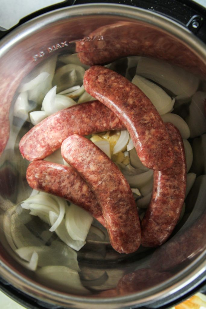 sausages and onions are cooking in an instant pot