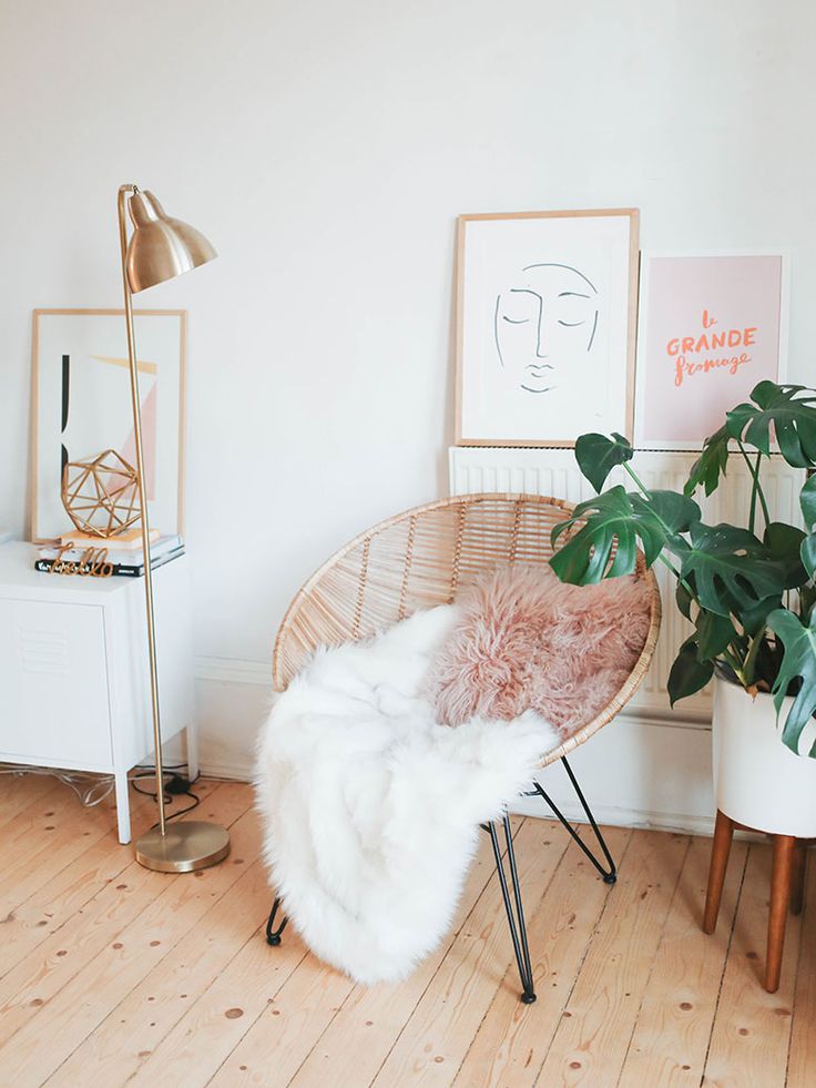 a room with some plants and pictures on the wall