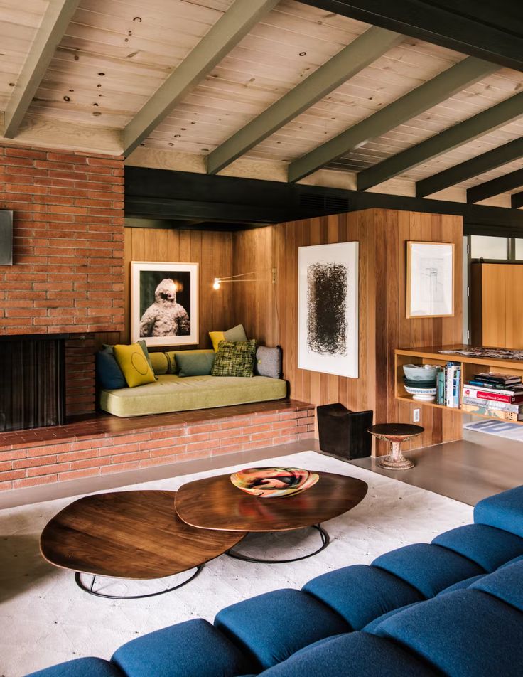 a living room filled with furniture and a fire place next to a wall mounted tv