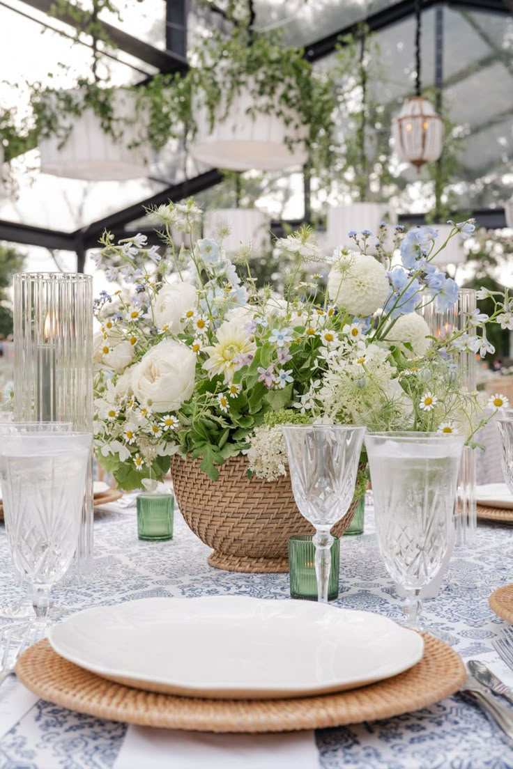 the table is set with flowers and wine glasses