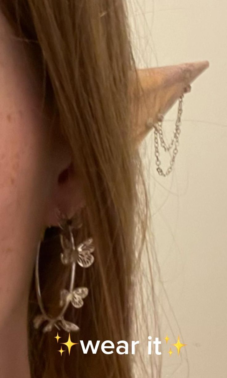 a close up of a person wearing earrings