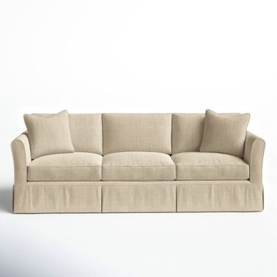 an image of a couch with pillows on the top and bottom part, in front of a white background