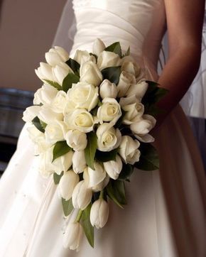 a bridal holding a bouquet of white flowers