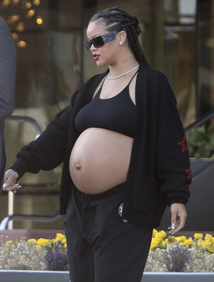 a pregnant woman walking down the street