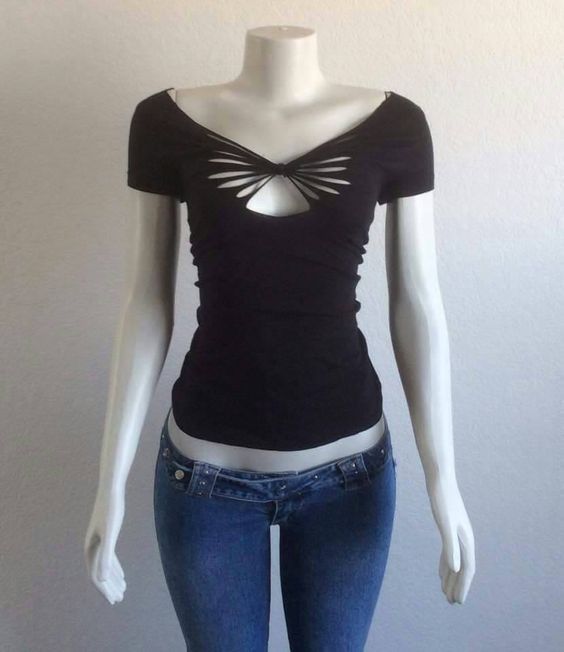 a female mannequin wearing jeans and a black shirt with cutouts on it