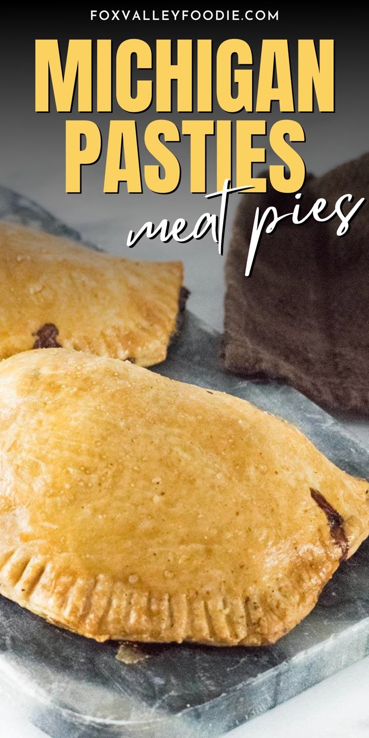 two pies sitting on top of a pan covered in cheese and brown sugar, with the words michigan pasties next to it