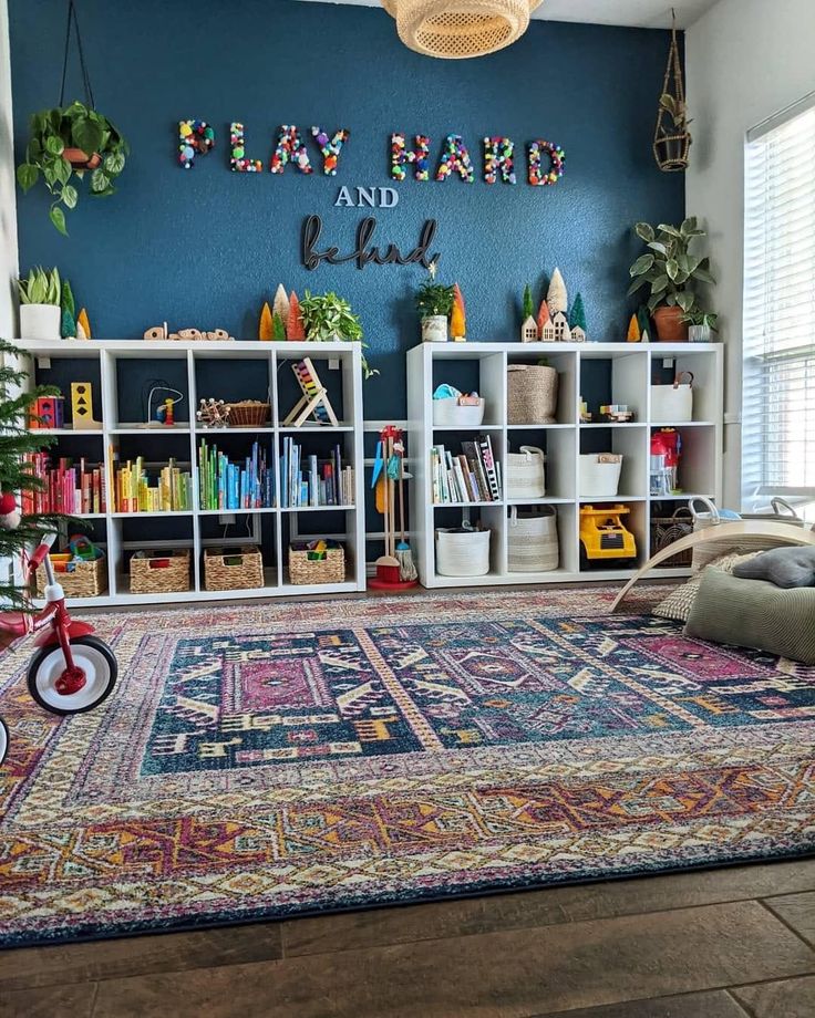 a living room filled with lots of furniture and bookshelves next to a blue wall