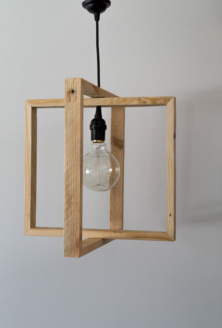 a light that is hanging from a wooden frame