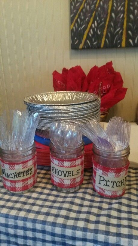 three jars filled with plastic wrap sitting on top of a checkered tablecloth covered table