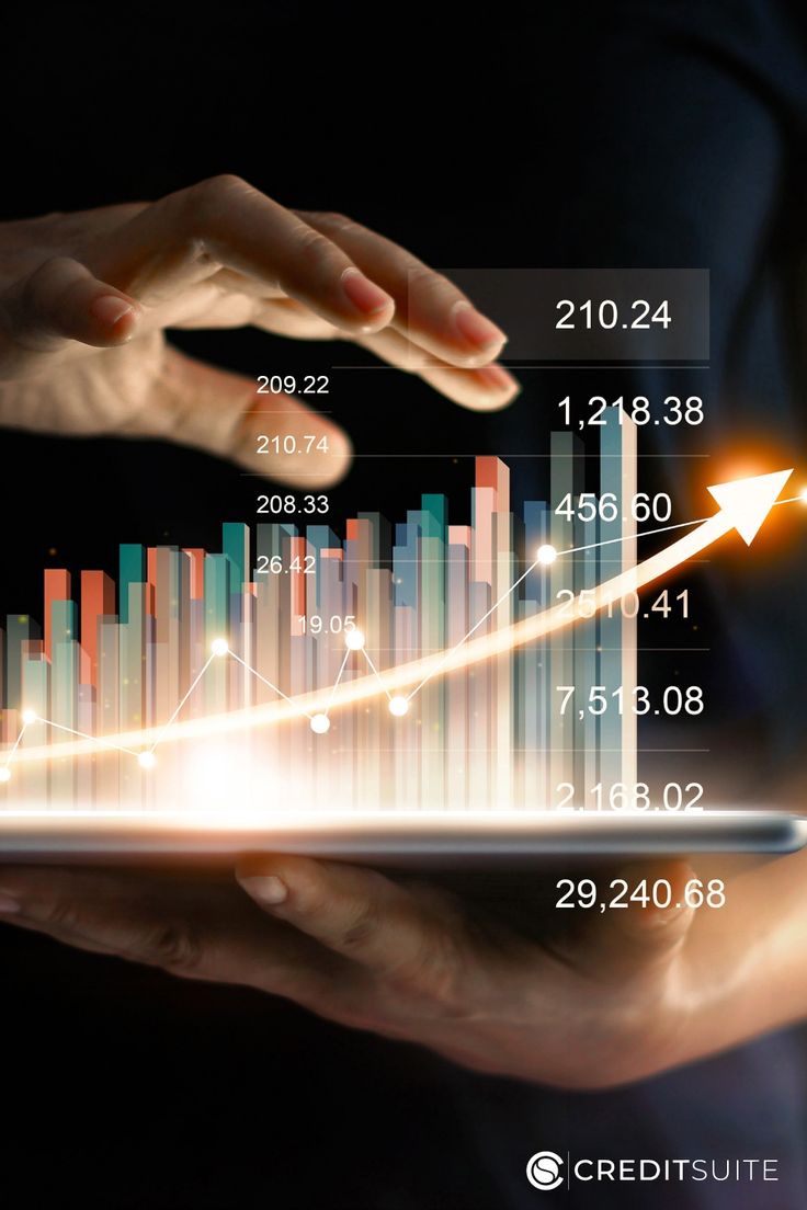 two hands holding a tablet with graphs on it