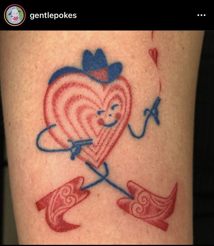 a heart with an arrow and bow tattoo on someone's leg