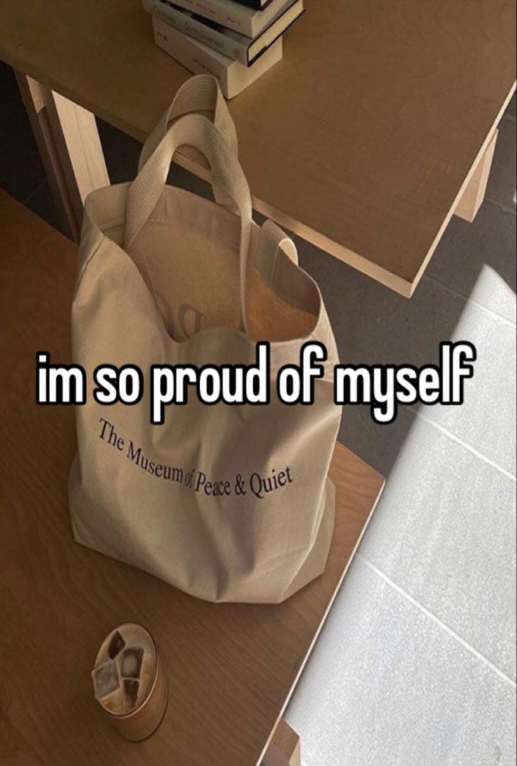 a white bag sitting on top of a wooden table next to a pair of shoes