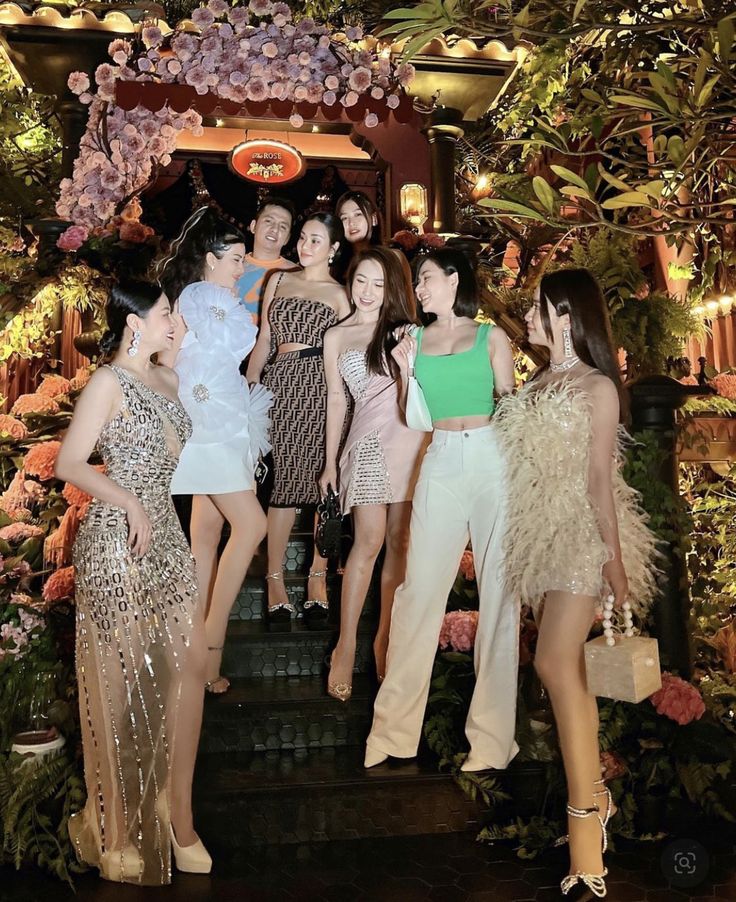 models pose in front of a floral display