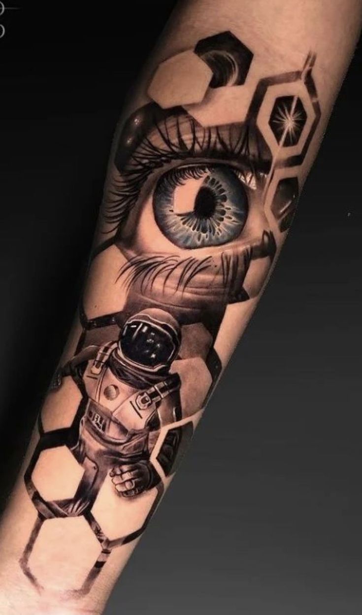 a tattoo with an eye and hexagons on the arm that is made up of