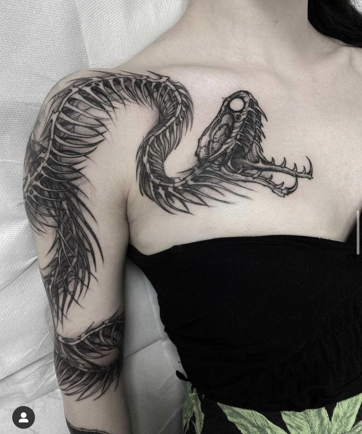 a woman with a dragon tattoo on her shoulder