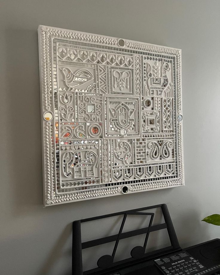 a white wall hanging over a keyboard on top of a desk